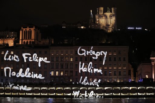 The first names of the 130 Paris attacks victims are spread over buildings in Lyon central France during a projection of French artist Daniel Knipper Tuesday Dec. 8 2015. Each year millions of visitors come into the city to watch the Festival des L