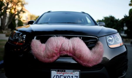 A driver with the ride-sharing service Lyft waits for a customer on a street in Santa Monica California