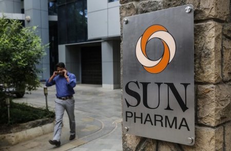 An employee speaks on phone as he walks out of research and development centre of Sun Pharmaceutical Industries Ltd in Mumbai