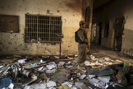 An army soldier stands in the Army Public School which was attacked by Taliban gunmen in Peshawar in this