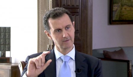 Syrian President Bashar al Assad speaks during a TV interview in Damascus Syria in this still image taken from a video