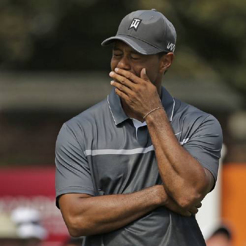 Tiger Woods reacts after missing a putt on the ninth hole during the second round of the Wyndham Championship golf tournament in Greensboro N.C. Tiger Woods painted a bleak