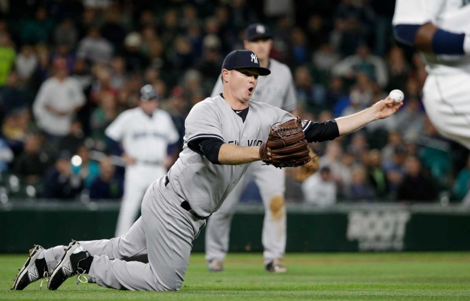 New York Yankees relief pitcher Justin Wilson throws to first to complete a double play against the Seattle Mariners in the 10th inning of a baseball game in Seattle. In a trade was announced on Wednesday Dec. 9