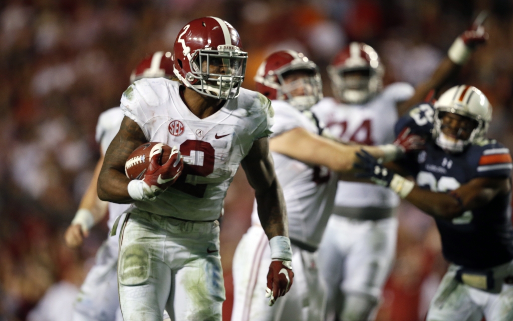 Alabama running back Derrick Henry runs the ball and scores a touchdown during the second half of an NCAA college football game against Auburn in Auburn Ala. No. 2 Alabama's offensive methods have changed but