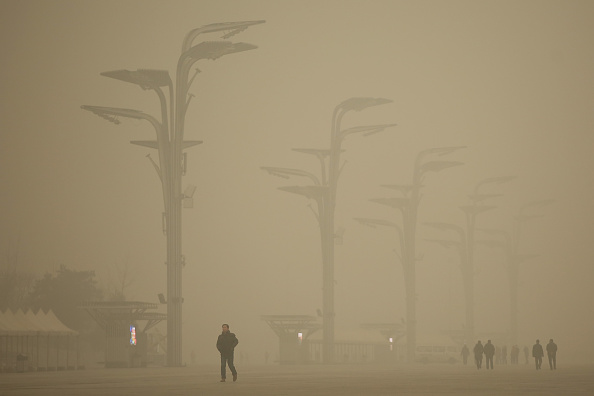 Tourists visit the Olympic Park during dheavy smog