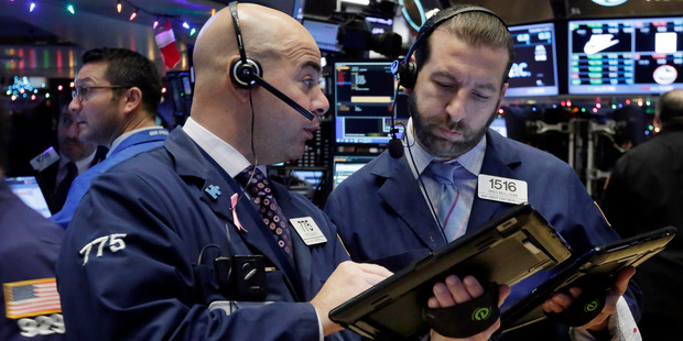 Traders Fred DeMarco left and Greg Mulligan work on the floor of the New York Stock Exchange. File