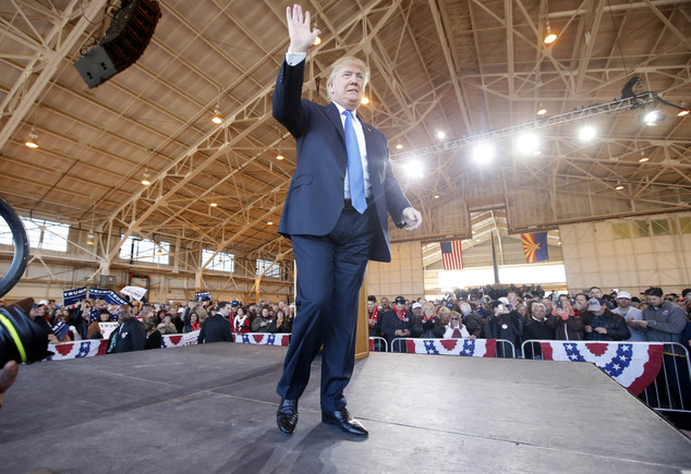 Republican presidential candidate Donald Trump waves after speaking at a campaign rally Wednesday Dec. 16 2015 in Mesa Ariz