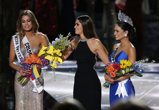 Former Miss Universe Paulina Vega center takes away the flowers and sash from Miss Colombia Ariadna Gutierrez left before giving them to Miss Philippines Pia Alonzo Wurtzbach right at the Miss Universe pageant on Sunday Dec. 20 2015 in Las Vegas