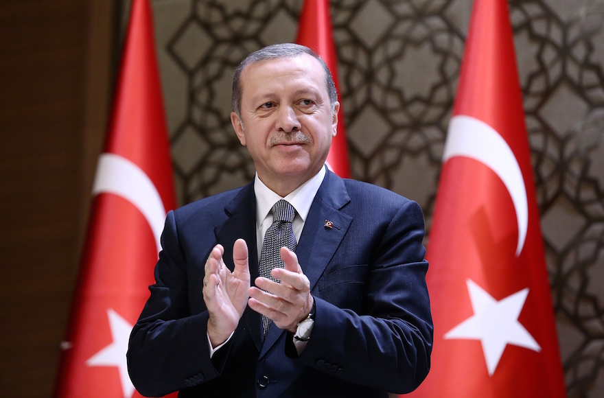 Turkish President Recep Tayyip Erdogan clapping during the 2015 Turkish Academy of Sciences award ceremony at Presidential Complex in Ankara Turkey Dec. 14 2015