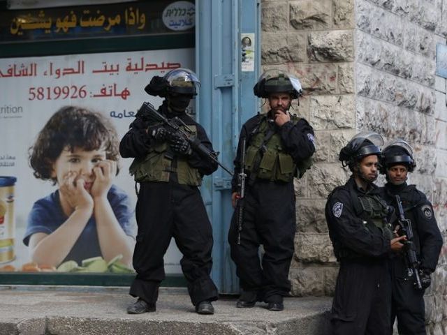 Israeli security forces stand guard in the east Jerusalem Shuafat refugee camp ahead of a planned demolition of a home of a Palestinian who carried out car-ramming attack last year