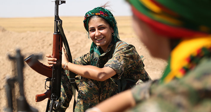 Female fighters from the Kurdish People Protection Unit take a break on the front line in the northeastern Syrian city of Hasakeh