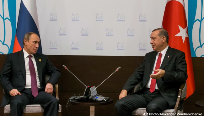 Russian President Vladimir Putin left and Turkish President Recep Tayyip Erdogan talk to each other as they pose for the media before their talks during the G-20 Summit in Antalya Turkey Monday Nov. 16 2015. (AP