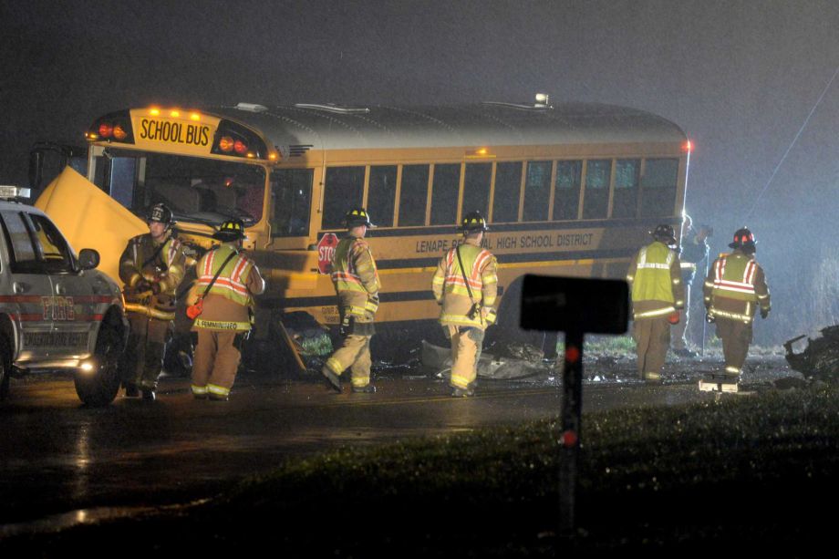 Authorities investigate the scene of an accident involving a school bus and a vehicle on Tuesday Dec. 1 2015 in Southampton N.J. State Police said the school bus and a vehicle collided leaving at least one person in the car seriously injured. (Tom Gr