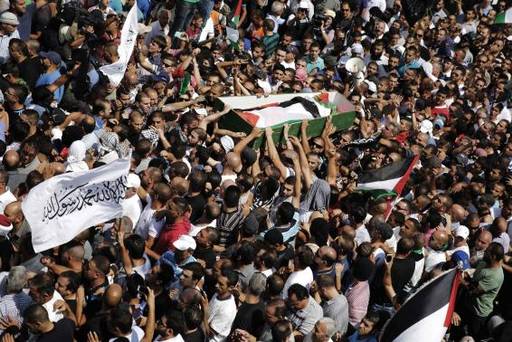 Palestinians carry the body of 16-year-old Mohammed Abu Khudair during his funeral in Shuafat an Arab suburb of Jerusalem