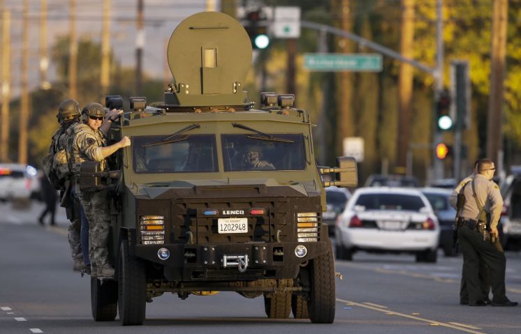 Authorities search an area near where police stopped a suspected vehicle in San Bernardino Calif. Wednesday Dec. 2 2015 following a shooting that killed multiple people at a social services center for the disabled. [Damian Dovarganes | Associated Pre