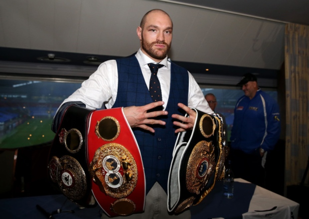 Tyson Fury holds his belts during a homecoming event at the Macron Stadium Bolton. Simon Cooper  PA Wire