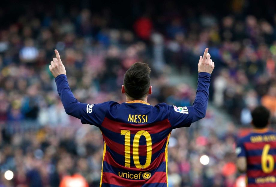 Barcelona's Lionel Messi celebrates scoring the opening goal during a Spanish La Liga soccer match between FC Barcelona and Deportivo Coruna at the Camp Nou stadium in Barcelona Spain Saturday Dec. 12 2015