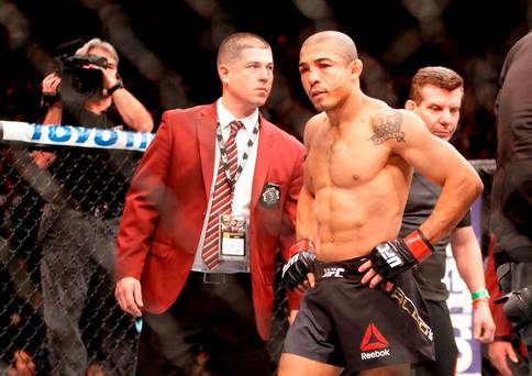 Jose Aldo walks across the Octagon after losing to Conor Mc Gregor in their featherweight title fight during UFC 194