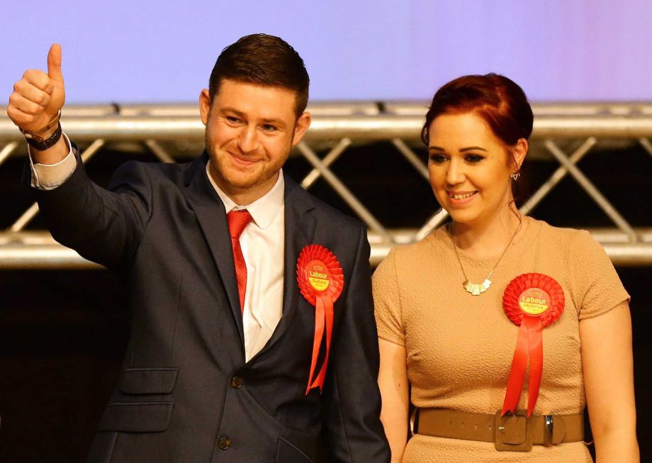 Labour candidate Jim McMahon left gestures as he stands with his partner Charlene as he celebrates victory after the Oldham West and Royton constituency by-election count in Oldham England Friday Dec. 4 2015. Britain's opposition Labour Party has