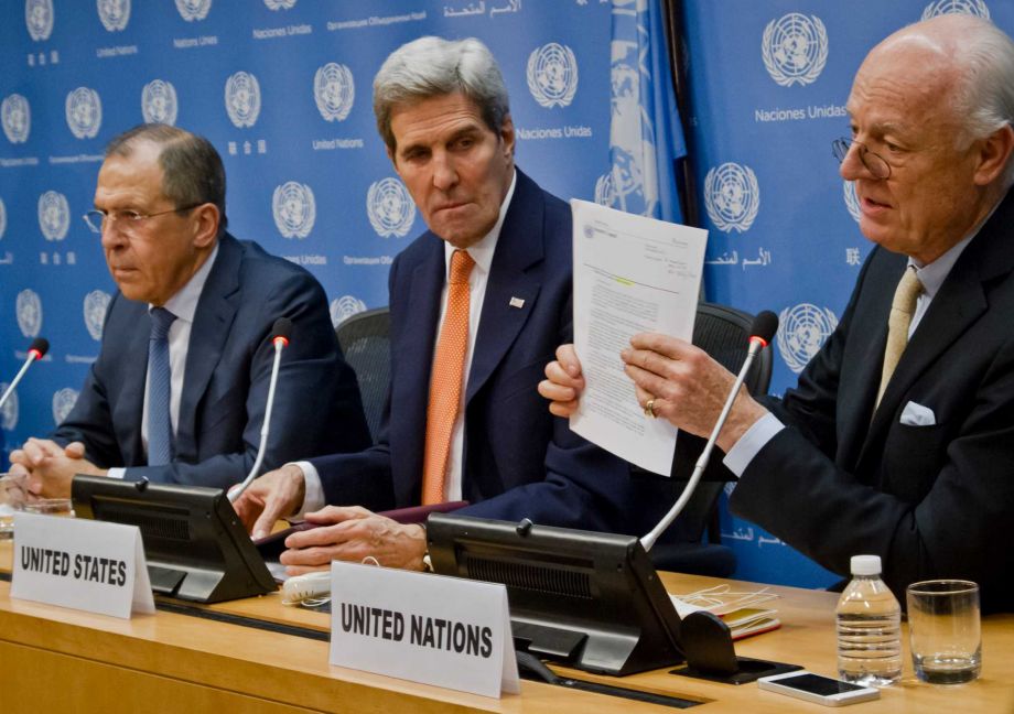 U.N. Special Envoy for Syria Staffan de Mistura right shows a copy of a Security Council resolution concerning Syria during a press conference with Russian Foreign Minister Sergey Lavrov left and U.S. Secretary of State John Kerry center Friday D