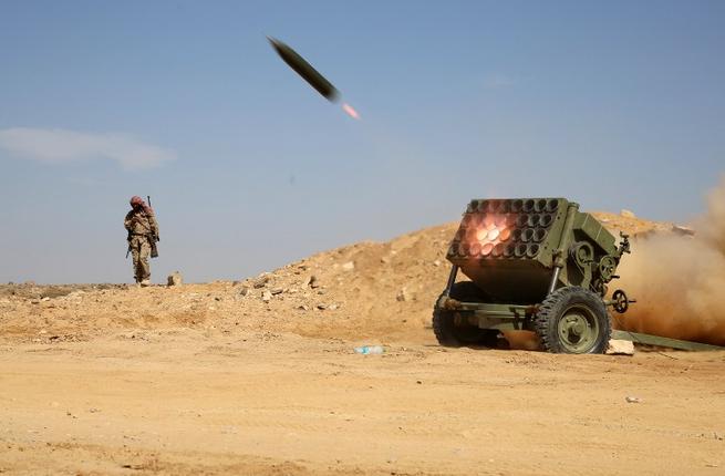 Armed Yemeni tribesmen from the Popular Resistance Committees supporting forces loyal to Yemen's Saudi-backed President Abedrabbo Mansour Hadi fire as they hold a position in the area of Sirwah west of Marib city