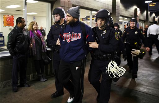 Law enforcement detained a protester at the Mall of America. A large protest that started at the Mall of America quickly migrated Wednesday Dec. 23 2015 to Minneapolis-St. Paul International Airport where demonstrators blocked roads and caused signifi