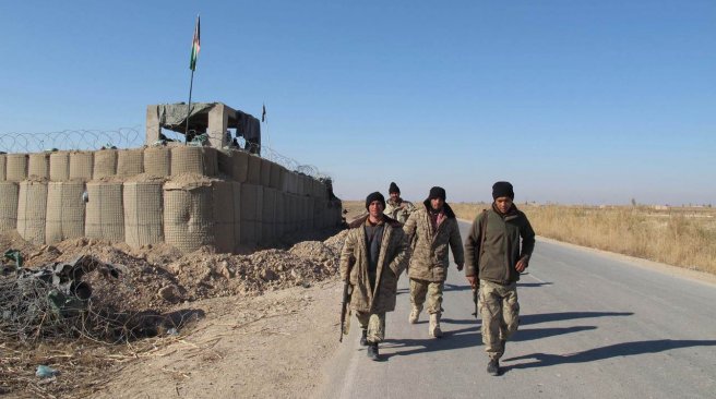 Afghan security forces patrol near their base in the Marjah district of Helmand Province