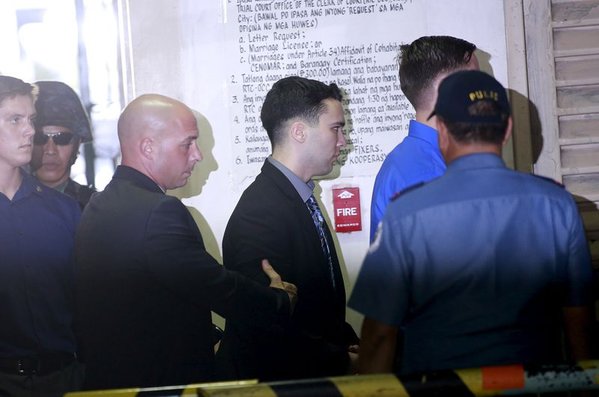 U.S. Marine Lance Corporal Joseph Scott Pemberton is escorted by U.S. security officers into a court in Olongapo city north of Manila