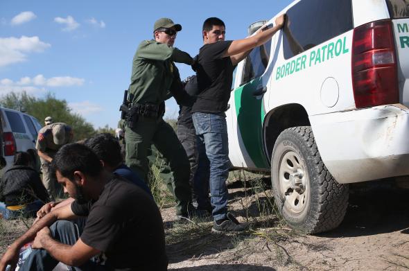 500414668-border-patrol-officer-body-searches-an-undocumented