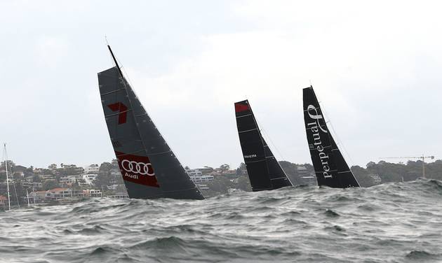 The sails of Wild Oats left Comanche center and Perpetual Loyal are seen as they sail out of the heads at the start of the Sydney Hobart yacht race in Sydney Saturday Dec. 26 2015. The 628-nautical-mile race started in Sydney Harbour and is expecte