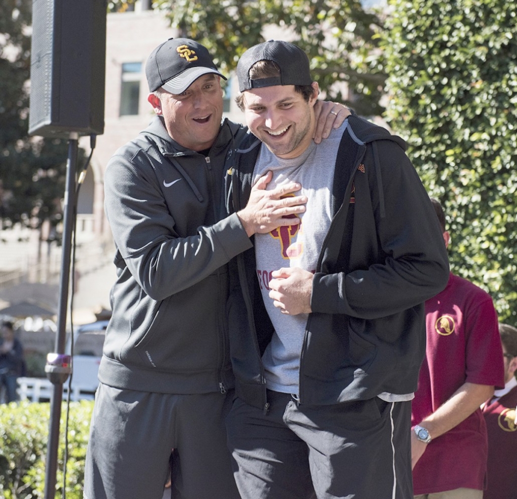 Eyeing victory · Redshirt senior quarterback Cody Kessler and head coach Clay Helton look toward the newly reclaimed Victory Bell which is back in USC’s hands after the team took down UCLA in its annual rivalry game.- Mariya Dondonyan | Daily Trojan