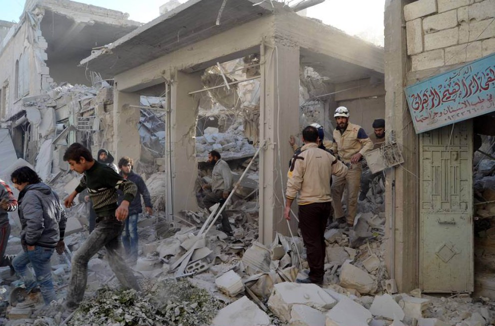 IDLIB SYRIA- NOVEMBER 29 Syrian civil defence members search for survivors in the rubble of a building following the Russian airstrikes targeting a market and residential area in Ariha town Idlib northern Syria