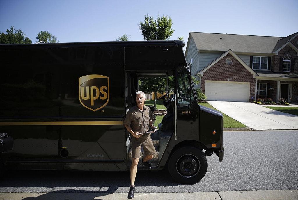 United Parcel Service driver Marty Thompson steps off a truck while making a delivery in Cumming Ga