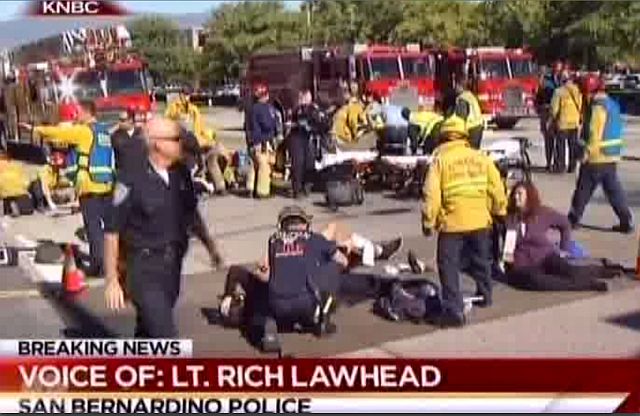 First responders attend to people outside a Southern California social services center in San Bernardino where one or more gunmen opened fire shooting more than 25 people