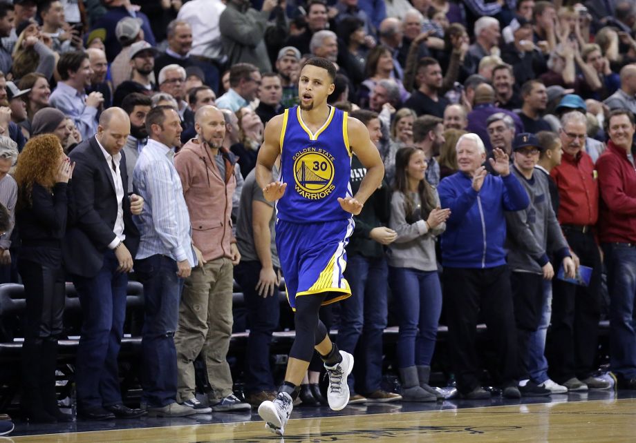 Golden State Warriors guard Stephen Curry runs back to his bench after making a 3-pointer against the Utah Jazz in the second half during an NBA basketball game Monday Nov. 30 2015 in Salt Lake City. Warriors won 106-103. Ph