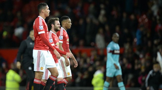 Manchester United defender Chris Smalling midfielder Juan Mata and striker Anthony Martial walk off the pitch after the English Premier League football match against West Ham United at Old Trafford in Manchester. AFP