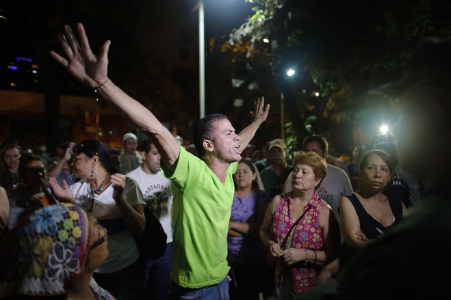 Opposition supporters celebrates the closing of a polling station during congressional elections in Caracas Venezuela Sunday Dec. 6 2015. Some members of the opposition are angry after elections officials ordered polling centers to stay open for an