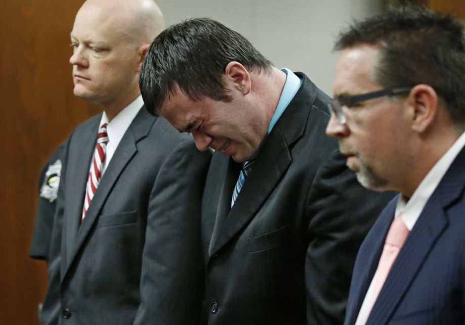 Daniel Holtzclaw flanked by defense attorneys Robert Gray and Scott Adams cries as he stands in front of the judge Thursday after the verdicts were read in his trial in Oklahoma City. Holtzclaw was found guilty of sex crimes against eight women