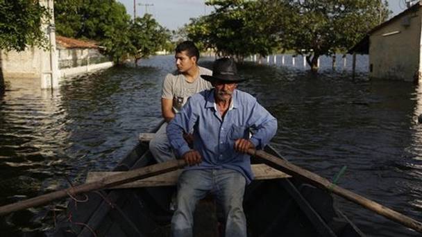 Victor Ferreira rows his boat through the streets of his Jukyty neighbourhood in Asuncion Paraguay