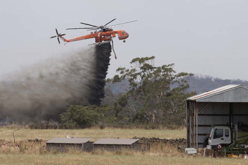 Australia Wildfire Skycrane helicopter drops water