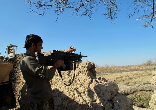 Armed Yemeni tribesmen from the Popular Resistance Committees fire as they hold a position in the area of Sirwah west of Marib city