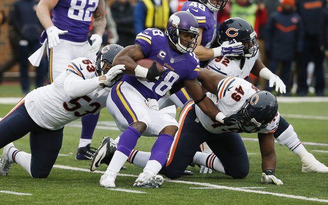 Minnesota Vikings running back Adrian Peterson is stopped by Chicago Bears linebacker John Timu and outside linebacker Sam Acho during the second half of an NFL football game Sunday Dec. 20 2015 in Minneapolis