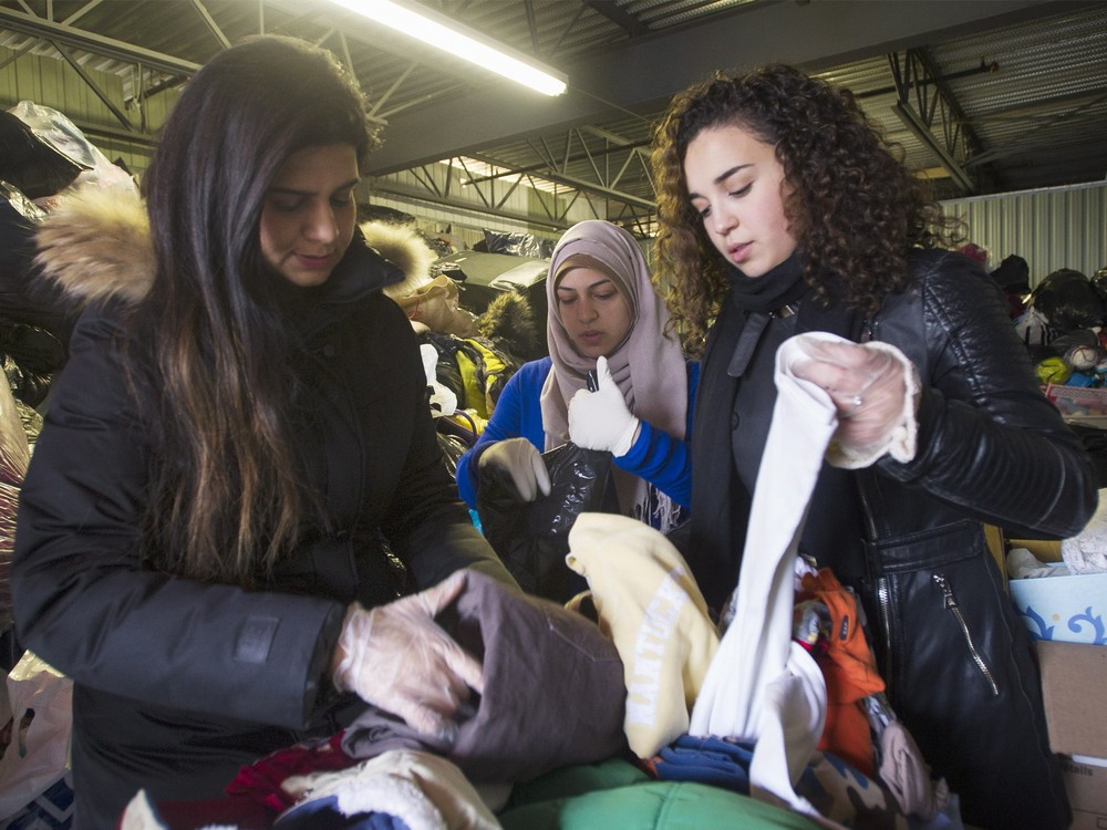 Volunteers sort through donated clothing for Syrian refugees at a depot in Montreal on Sunday Nov. 29 2015