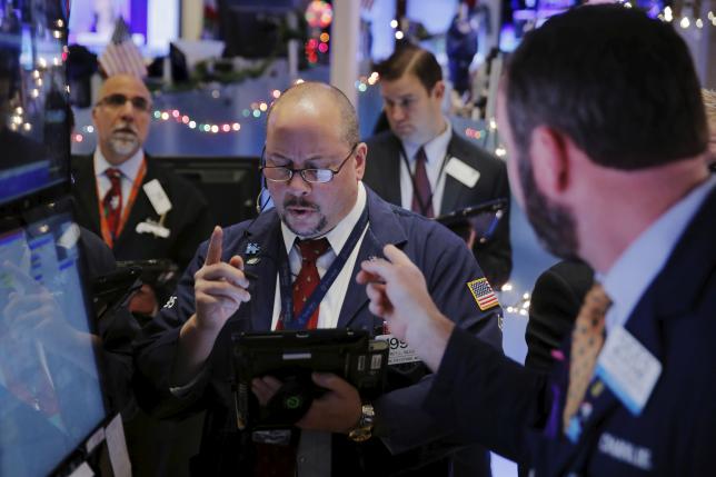 Traders work shortly after the opening bell on the floor of the New York Stock Exchange in the Manhattan borough of New York