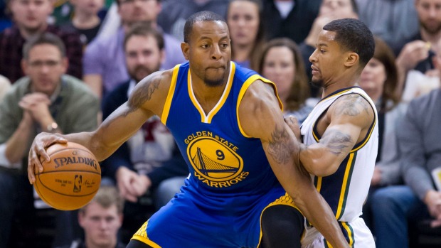 Golden State forward Andre Iguodala posts up Utah Jazz guard Trey Burke during the Warriors 19th straight win to start the NBA season