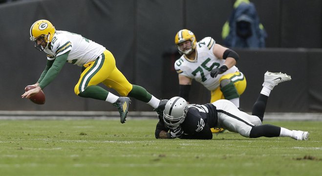 Packers quarterback Aaron Rodgers is sacked by Oakland Raiders defensive end Khalil Mack