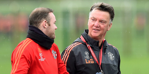 Manchester United manager Louis van Gaal right talks with Wayne Rooney during a training session at the team's training complex in Manchester