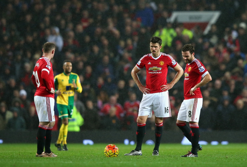 MANCHESTER ENGLAND- DECEMBER 19  Wayne Rooney Michael Carrick and Juan Mata of Manchester United reacts after Norwich City's second goal during the Barclays Premier League match between Manchester United and Norwich City at Old Trafford on De