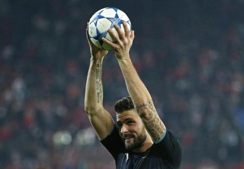 Arsenal's Olivier Giroud celebrates with the matchball after scoring a hat trick at the end of the Group F match against Olympiacos of UEFA Champions League in the Georgios Karaiskakis Stadium Piraeus Greece