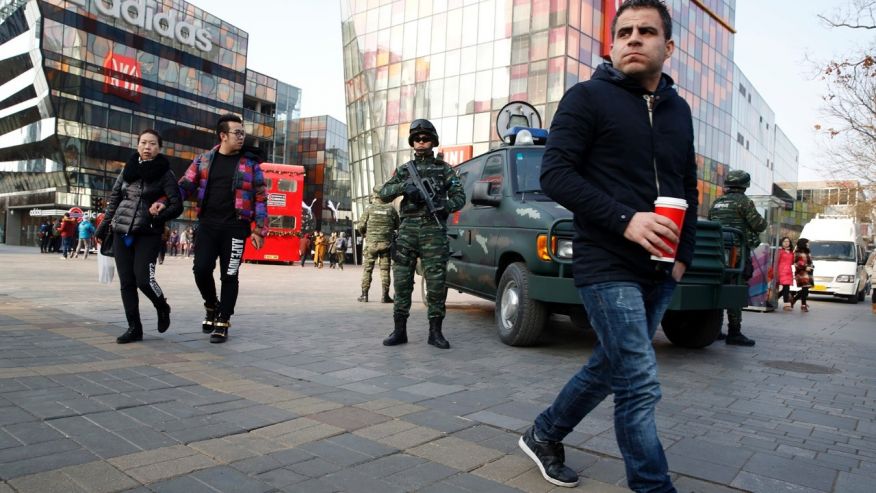 Heavily armed Chinese paramilitary police guard a popular mall in the Sanlitun district of Beijing China Thursday Dec. 24 2015. Increased security could be seen in the area as the U.S. and British embassies in the Chinese capital issued travel alerts